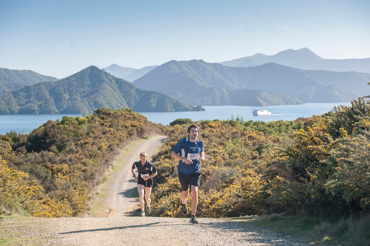 Two runners jog up a gravel road during the picturesque Marine 2 Marina competition